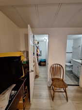 Sitting room featuring light wood finished floors and a decorative wall
