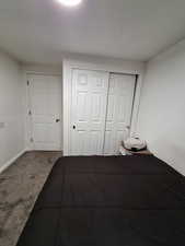 Bedroom featuring carpet and a closet