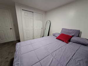 Bedroom with carpet and a closet