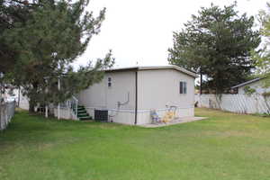 View of home's vast exterior featuring a fenced backyard