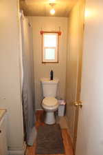 Full bath with light wood-style floors, vanity, and a stall shower