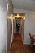 Corridor featuring dark wood-style floors