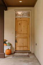 Entrance to property with stucco siding