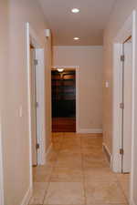 Corridor featuring recessed lighting and light tile patterned flooring