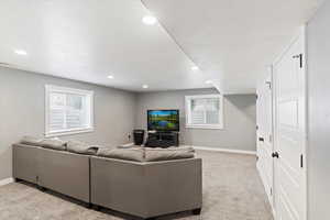 Living room with plenty of natural light, recessed lighting, and light carpet