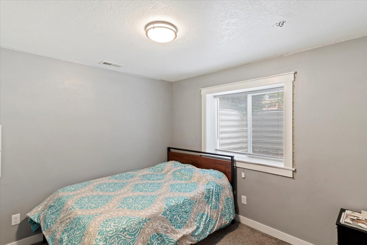 Bedroom with carpet floors and a textured ceiling