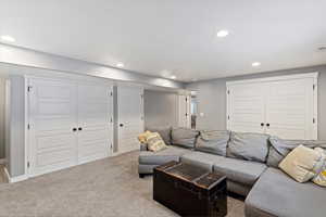 Carpeted living room featuring recessed lighting