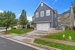 Traditional-style home with an attached garage, stucco siding, and driveway