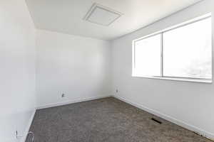 Bedroom #2 featuring baseboards and attic access