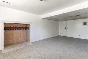 Family room with light carpet and a paneled ceiling