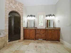 Bathroom with double vanity and a stall shower