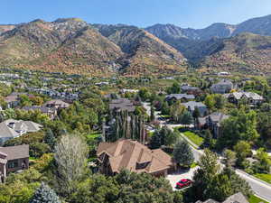 Aerial overview of property's location featuring a mountain backdrop and nearby suburban area