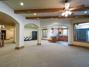 Gathering room featuring arched walkways, recessed lighting, light colored carpet, beamed ceiling, and a ceiling fan