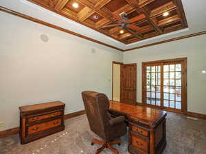 Home office featuring crown molding, coffered ceiling, a ceiling fan, dark carpet, and a wood ceiling with exposed beams