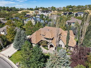 View of subject property with a tree filled landscape