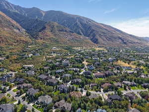 Aerial view of property's location with a mountainous background and nearby suburban area