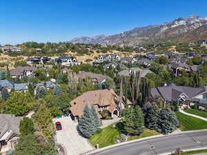 Aerial overview of property's location with a mountainous background and nearby suburban area