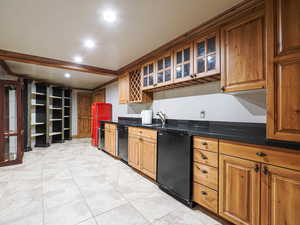 Kitchen featuring ornamental molding, glass insert cabinets, black dishwasher, freestanding refrigerator, and brown cabinetry