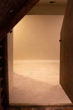 Hallway featuring carpet floors