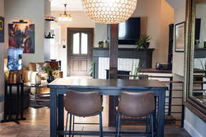 Kitchen with a kitchen bar, dark tile patterned flooring, and a chandelier