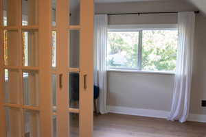 Misc room with light wood finished floors and baseboards