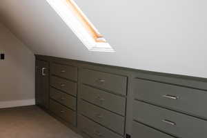 Detailed view of carpet flooring and a skylight