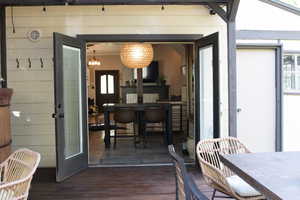 Dining area with a chandelier and dark wood-style flooring