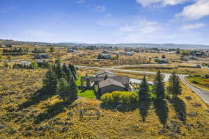 Aerial view of property and surrounding area featuring a mountain backdrop