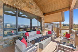 Deck with an outdoor living space with a fire pit and a mountain view