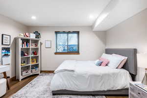 Bedroom with dark wood-style flooring and recessed lighting