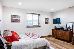Bedroom with light wood finished floors and recessed lighting