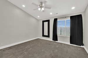 Carpeted spare room with a ceiling fan and recessed lighting