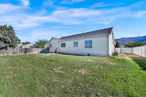 Rear view of property featuring a fenced backyard