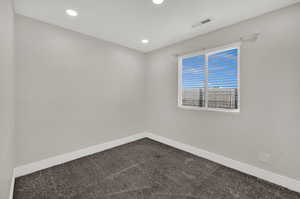 Unfurnished room featuring dark carpet and recessed lighting