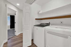 Laundry area featuring light wood-style flooring, washing machine and dryer, and recessed lighting