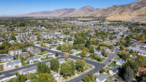 Aerial overview of property's location with nearby suburban area and a mountain backdrop