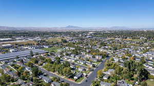 Aerial view of property and surrounding area featuring nearby suburban area