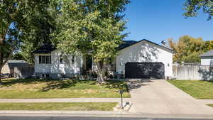 View of front of house featuring driveway and a garage