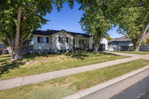 View of front of house featuring driveway and a porch