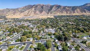 Aerial view of property's location featuring nearby suburban area and mountains