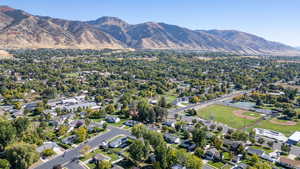 Aerial view of property's location with a mountainous background and nearby suburban area