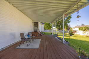 Wooden terrace with a fenced backyard and entry steps
