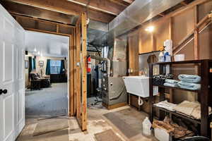 Below grade area with heating unit and a water softener system