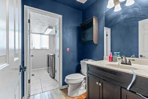 Half bathroom leading into laundry room