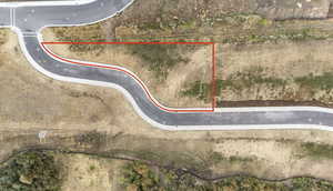 Aerial view of property and surrounding area featuring property parcel outlined