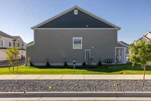 View of side of home with a lawn