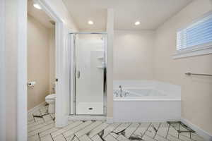 Full bath featuring a bath, a shower stall, and recessed lighting