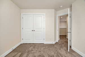 Unfurnished bedroom featuring carpet, a closet, and recessed lighting