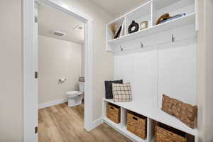 Mudroom featuring light wood-style floors and baseboards