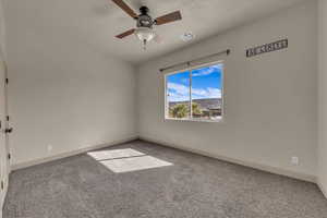 Unfurnished room with light colored carpet and ceiling fan